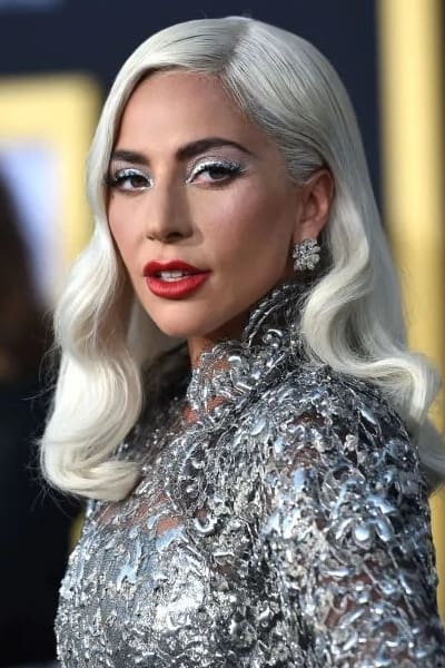 a woman with long white hair and red lips